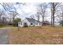 View of a home's exterior with trees on a large lot at 609 Eddleman Rd, Kannapolis, NC 28083