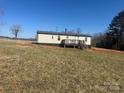 Backyard view of the home showing the deck and siding on the home at 8183 Hallman Mill Rd, Vale, NC 28168