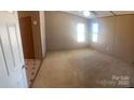 Spacious main bedroom with neutral carpet, a ceiling fan, and two large windows at 8183 Hallman Mill Rd, Vale, NC 28168