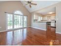 Bright living room featuring hardwood floors and large windows with abundant natural light at 9307 Harlow Creek Rd, Huntersville, NC 28078