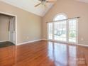 Sun-drenched living room with hardwood floors and an arched window at 9307 Harlow Creek Rd, Huntersville, NC 28078