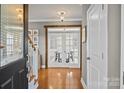 Bright foyer with hardwood floors and glass french doors leading to dining room at 10011 Roosevelt Dr, Huntersville, NC 28078