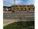 Modern, multi-unit building under construction with newly installed framing and foundation on a sunny day at 1011 Carter Ave # 35, Charlotte, NC 28206