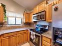 This kitchen shows stainless steel appliances, wood cabinets, and granite countertops at 1022 Mallard Head Ln, Mooresville, NC 28117
