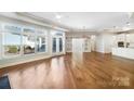 Open-concept living area boasts hardwood floors, French doors, and a modern chandelier, perfect for gatherings at 1063 Millview Ln, Matthews, NC 28104