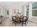 Inviting dining room featuring a round table, stylish chairs, modern lighting, and large windows at 109 Seldon Dr, Charlotte, NC 28216