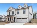 Charming two-story home featuring white siding, black window frames, and a convenient two-car garage at 109 Seldon Dr, Charlotte, NC 28216