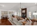 Open-concept living room featuring hardwood floors, a modern fireplace, and abundant natural light at 11 Woodvine Ln, Clover, SC 29710