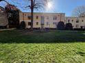 Apartment complex featuring a well-maintained lawn and mature landscaping in a lush, sunny setting at 1121 Myrtle Ave # 17, Charlotte, NC 28203
