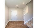 Welcoming entryway with wood-look flooring and a staircase leading to the upper level at 12128 Lady Bell Dr, Charlotte, NC 28278