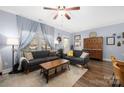 Comfortable living room with hardwood floors, modern furniture, and large windows with natural light at 12304 Huntersville Concord Rd, Huntersville, NC 28078