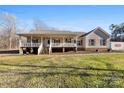 Charming one-story home with a covered porch and a well-manicured lawn at 1298 Hines Rd, Clover, SC 29710