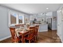 Bright dining area with hardwood floors and views into the kitchen at 13913 Queens Harbor Rd, Charlotte, NC 28278