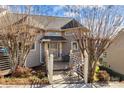 Inviting townhome entrance with a charming porch and seating area at 13913 Queens Harbor Rd, Charlotte, NC 28278