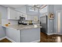 Modern kitchen featuring granite countertops and stainless steel appliances at 13913 Queens Harbor Rd, Charlotte, NC 28278