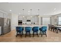 Bright kitchen features a large island with bar seating, stainless steel appliances, and adjacent dining area at 168 Kennerly Center Dr, Mooresville, NC 28115