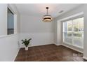 Bright dining room with large window, tile floors and bead board trim at 17537 Tuscany Ln, Cornelius, NC 28031