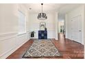Open dining room with modern chandelier, neutral paint, hardwood floors and abundant natural light at 181 Atwater Landing Dr, Mooresville, NC 28117