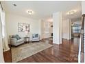 Bright living room with hardwood floors, neutral paint, area rug, and elegant furniture at 181 Atwater Landing Dr, Mooresville, NC 28117
