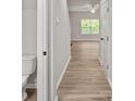 Hallway with durable light wood flooring flowing into a living space with natural light at 200 Lake George Dr, Shelby, NC 28152