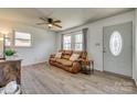 Bright living room featuring wood floors, a leather couch, and neutral-colored walls at 2027 Franklin St, Rock Hill, SC 29732