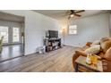 Comfortable living area with a flatscreen TV, wooden floors, and a ceiling fan at 2027 Franklin St, Rock Hill, SC 29732