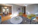 Open floor plan with a view of the living room and dining area with hardwood floors at 2036 Edgewater Dr, Charlotte, NC 28210