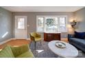 Inviting living room featuring hardwood floors, a gray sofa, and lots of natural light at 2036 Edgewater Dr, Charlotte, NC 28210