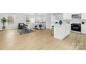 Bright and airy open-concept living space with wood flooring and modern furnishings at 220 King George Ln, Gastonia, NC 28056
