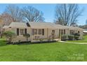Charming, one-story home featuring a manicured lawn and a freshly painted exterior with black window shutters at 2509 Wesley Chapel Rd, Indian Trail, NC 28079