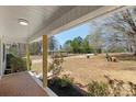 Relaxing on the covered porch of this home with views of the landscaped front yard at 2509 Wesley Chapel Rd, Indian Trail, NC 28079