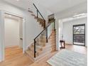 Modern entryway featuring a glass-railed staircase and light wood flooring for a bright, open feel at 3416 Windsor Dr, Charlotte, NC 28209