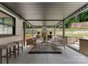Inviting outdoor patio with comfortable seating, stone fireplace, and pergola for shaded relaxation at 3416 Windsor Dr, Charlotte, NC 28209