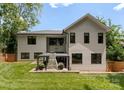 A well maintained backyard featuring a covered outdoor fireplace, perfect for entertaining and relaxation at 3416 Windsor Dr, Charlotte, NC 28209