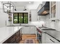 Gourmet kitchen featuring custom white cabinetry, an island, and stainless steel appliances at 406 Morrison Farm Rd, Troutman, NC 28166