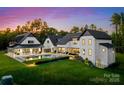 Expansive backyard featuring a pool, lounge chairs, covered porch, and lush landscaping at 406 Morrison Farm Rd, Troutman, NC 28166