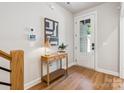 Inviting entryway with wood floors, stylish console table, and decorative artwork at 408 Old Town Village Rd, Waxhaw, NC 28173