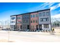 Row of new townhomes with varied architectural styles, landscaping, and a bright blue sky at 408 Old Town Village Rd, Waxhaw, NC 28173