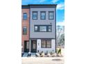 A gray and white townhome with dark window trim and a well manicured lawn at 408 Old Town Village Rd, Waxhaw, NC 28173