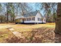 Exterior of a charming home with a covered front porch, and mature landscaping at 4221 E Maiden Rd, Maiden, NC 28650