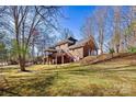 Back exterior view of brick home with wooden deck, stairs to backyard and garage at 4340 Rodeway Ne Ct, Hickory, NC 28601