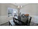 Bright dining area with large window and dark wood furniture, perfect for entertaining or Gathering meals at 4631 Christina Ct, Gastonia, NC 28056