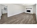 Spacious living room with hardwood floors and a white brick fireplace at 5012 Maplecrest Dr, Gastonia, NC 28056