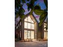 Modern home featuring a two-story wall of windows and striking architectural details at 5500 Carmel Rd # 101, Charlotte, NC 28226