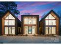 New modern home featuring unique architectural design, large windows, and pristine curb appeal at 5500 Carmel Rd # 101, Charlotte, NC 28226