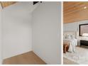 Hallway view leading to bedroom, features wood ceiling, clean lines, and minimalist design at 5500 Carmel Rd # 103, Charlotte, NC 28226