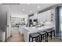 Bright, open kitchen with white cabinets, stainless appliances, and central island at 6033 Fonsac Ln # 2008B, Charlotte, NC 28217