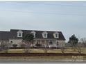 Charming one-story home with dormer windows, a covered front porch, and landscaping at 6795 Jones Rd, Salisbury, NC 28147