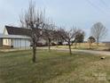 Inviting one-story home featuring a covered parking area, an attached garage and well-maintained front yard at 6795 Jones Rd, Salisbury, NC 28147