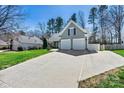 Attractive home with a two-car garage and a wide driveway, nestled among mature trees at 7331 Sedgebrook W Dr, Stanley, NC 28164